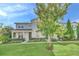 Two-story townhome with light blue siding, landscaping, and a tree in front at 2102 Gopher Tortoise Ter, Oakland, FL 34787