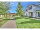 Two-story townhome with light blue siding, landscaping, and a paved pathway at 2102 Gopher Tortoise Ter, Oakland, FL 34787