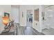 Foyer with gray wood-look floors, console table, and view into bathroom and office at 2102 Gopher Tortoise Ter, Oakland, FL 34787