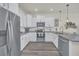 White kitchen with stainless steel appliances and granite countertops at 2102 Gopher Tortoise Ter, Oakland, FL 34787