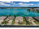 Stunning aerial view of waterfront homes on a sunny day with blue skies and calm lake at 219 Blue Cypress Dr, Groveland, FL 34736