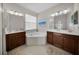 Elegant bathroom with a corner soaking tub and double vanity at 219 Blue Cypress Dr, Groveland, FL 34736