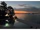 Stunning sunset over lake with pool in foreground at 219 Blue Cypress Dr, Groveland, FL 34736