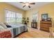 Charming bedroom with hardwood floors, large windows, ceiling fan, and dresser at 220 Riverview Blvd, Daytona Beach, FL 32118