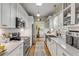 Modern kitchen with white cabinets, stainless steel appliances and quartz countertops at 220 Riverview Blvd, Daytona Beach, FL 32118