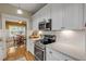 Modern kitchen with white cabinets, stainless steel appliances and view to dining area at 220 Riverview Blvd, Daytona Beach, FL 32118