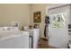 Bright laundry room with washer, dryer, and exterior access at 220 Riverview Blvd, Daytona Beach, FL 32118