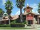 Community clubhouse with red roof and shutters at 2216 Grand Cayman Ct # 1411, Kissimmee, FL 34741