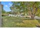 A well-maintained backyard with green grass and mature trees at 233 Bluejay Way, Orlando, FL 32828