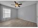 Neutral bedroom featuring a ceiling fan, stylish tile floors, light gray walls, and ample natural light at 233 Bluejay Way, Orlando, FL 32828