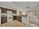 Functional kitchen featuring granite countertops and white appliances at 233 Bluejay Way, Orlando, FL 32828