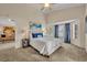 Vaulted ceiling main bedroom with bright windows, neutral walls, and a view into the living room at 233 Bluejay Way, Orlando, FL 32828