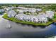 Aerial view of waterfront community with lake and fountain at 2512 Woodgate Blvd # 105, Orlando, FL 32822