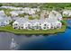 Aerial view of waterfront community with lake and fountain at 2512 Woodgate Blvd # 105, Orlando, FL 32822