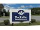 Dockside Condominiums sign at entrance at 2512 Woodgate Blvd # 105, Orlando, FL 32822