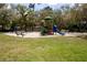 playground with swings and slides in a grassy area at 282 S Fox Chase Pt, Longwood, FL 32779