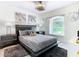 Well-lit bedroom with gray bedding and a large window at 3211 Sunrise Walk, Kissimmee, FL 34747