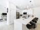 Modern white kitchen with stainless steel appliances and breakfast bar at 3211 Sunrise Walk, Kissimmee, FL 34747