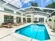 Inviting pool area with spa, covered patio, and lounge chairs at 3211 Sunrise Walk, Kissimmee, FL 34747