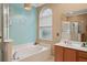 Bathroom with a large soaking tub, double vanity, and a separate shower at 33925 Terragona Dr, Sorrento, FL 32776