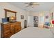 Main bedroom with large dresser, en-suite bathroom access, and sitting area at 33925 Terragona Dr, Sorrento, FL 32776