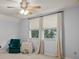 Bedroom with large window, ceiling fan, and seating area at 33925 Terragona Dr, Sorrento, FL 32776