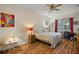 Bedroom featuring hardwood floors, a ceiling fan, and natural light at 33925 Terragona Dr, Sorrento, FL 32776