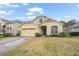 Two-story house with a paved driveway and yard at 33925 Terragona Dr, Sorrento, FL 32776