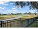 Scenic view of a golf course from behind a fence at 33925 Terragona Dr, Sorrento, FL 32776