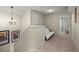 Upstairs hallway with neutral carpeting, decorative chandelier, and a futon for relaxing at 33925 Terragona Dr, Sorrento, FL 32776