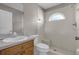 Bathroom with shower, toilet and wood vanity at 38100 Ricker Dr, Lady Lake, FL 32159