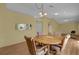 Round wooden dining table with four chairs in a bright room at 38100 Ricker Dr, Lady Lake, FL 32159