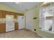 Kitchen with wood cabinets, white appliances, and tiled floor at 38100 Ricker Dr, Lady Lake, FL 32159