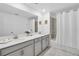 Elegant bathroom featuring double vanity and bathtub at 4299 Paragraph Dr, Kissimmee, FL 34746