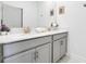 Double vanity bathroom with gray cabinets and quartz countertops at 4299 Paragraph Dr, Kissimmee, FL 34746