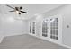 Bright bedroom with gray walls and French doors at 4382 Weeping Willow Cir, Casselberry, FL 32707