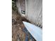 Overgrown backyard with a small boat near the house at 5238 Macadamia Ct, Orlando, FL 32818