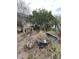 Overgrown backyard with various debris and plants at 5238 Macadamia Ct, Orlando, FL 32818