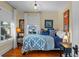 Bedroom with blue and white quilt and hardwood floors at 549 Glenway Dr, Sanford, FL 32771