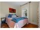 Bedroom with pink walls, blue bedding, and wood floors at 549 Glenway Dr, Sanford, FL 32771