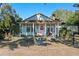 Light blue house with pink door and welcoming porch at 549 Glenway Dr, Sanford, FL 32771