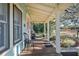 Inviting front porch with wooden flooring and two chairs, shaded by a roof at 549 Glenway Dr, Sanford, FL 32771