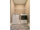 Convenient laundry room with washer and dryer and overhead shelving at 5814 Bimini Twist Loop, Orlando, FL 32819