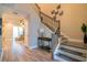 Modern staircase with dark metal railing and light wood steps at 5814 Bimini Twist Loop, Orlando, FL 32819