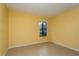 Bright bedroom with tile flooring and window at 5896 Peregrine Ave # C01, Orlando, FL 32819