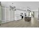 Open concept dining room with chandelier and kitchen view at 609 Bayhawk St, Debary, FL 32713