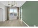 Modern dining room with green accent wall and window at 609 Bayhawk St, Debary, FL 32713