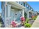 Townhome entrance with light teal door, stone accents, and lush landscaping at 609 Bayhawk St, Debary, FL 32713