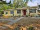 Charming yellow single-story home with a red door and a well-kept front yard at 6254 Balboa Dr, Orlando, FL 32808