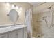 Bathroom featuring a walk-in shower and marble vanity at 6663 Queens Borough Ave # 108, Orlando, FL 32835